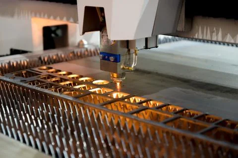 High precision CNC laser cutting metal sheet and metal pipe in factory. Stock Photos