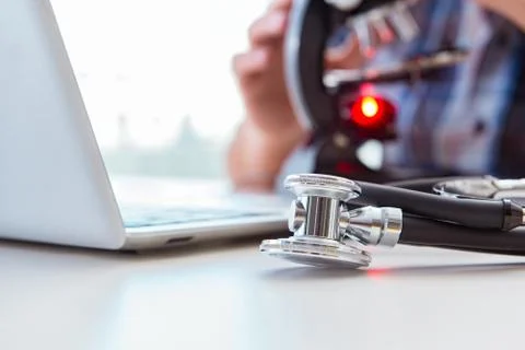 High precision engineering with man working with microscope Stock Photos