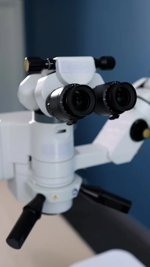 High-precision surgical microscope with dual eyepieces and adjustable focus, Stock Footage 337386159