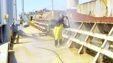 High Pressure Cleaning: Sailor Removing Rust on Commercial Cargo VesselHigh Pres Stock Footage 329250732