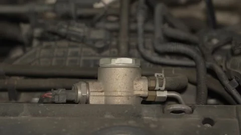 A high-pressure fuel pump mounted on a car engine. Vídeo Stock 342260764