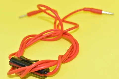 High-quality audio cable for display in yellow background. Stock Photos