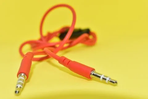 High-quality audio cable for display in yellow background. Stock Photos