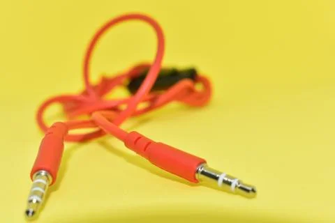 High-quality audio cable for display in yellow background. Stock Photos