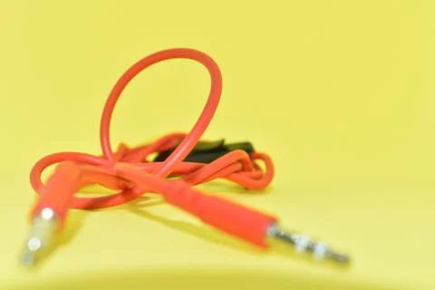 High-quality audio cable for display in yellow background. Stock Photos