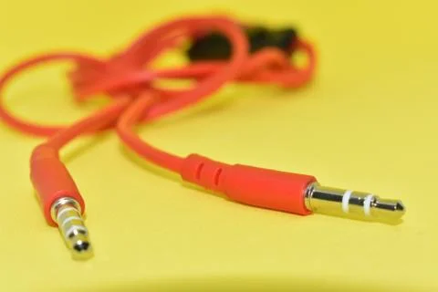 High-quality audio cable for display in yellow background. Stock Photos