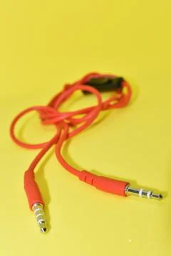 High-quality audio cable for display in yellow background. Stock Photos