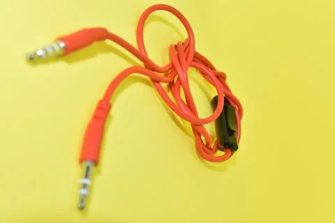 High-quality audio cable for display in yellow background. Stock Photos