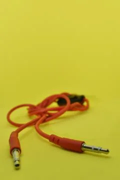 High-quality audio cable for display in yellow background. Stock Photos