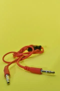 High-quality audio cable for display in yellow background. Stock Photos