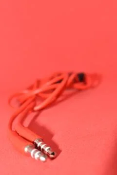 High-quality audio cable for display in red background. Stock Photos