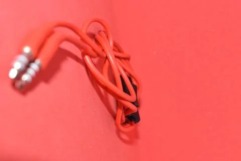 High-quality audio cable for display in red background. Stock Photos