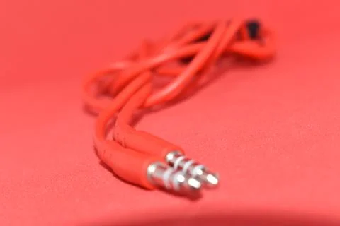 High-quality audio cable for display in red background. Stock Photos
