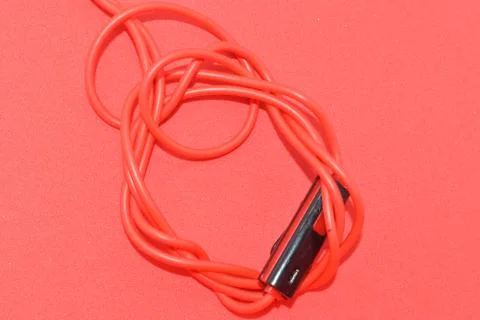 High-quality audio cable for display in red background. Stock Photos