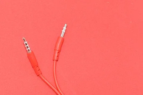 High-quality audio cable for display in red background. Stock Photos