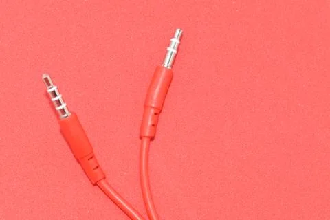 High-quality audio cable for display in red background. Stock Photos