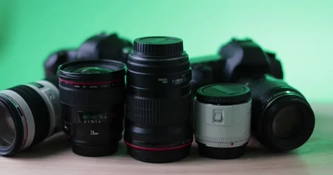 High quality brand camera and filming lenses on simple green Background Stock Footage 237547078
