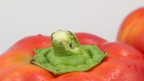 High-quality close-up of a spinning red bell pepper, isolated on white Stock Footage 296825414