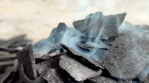 High quality coconut shell charcoal emits thin smoke when burning Stock Footage 336761948