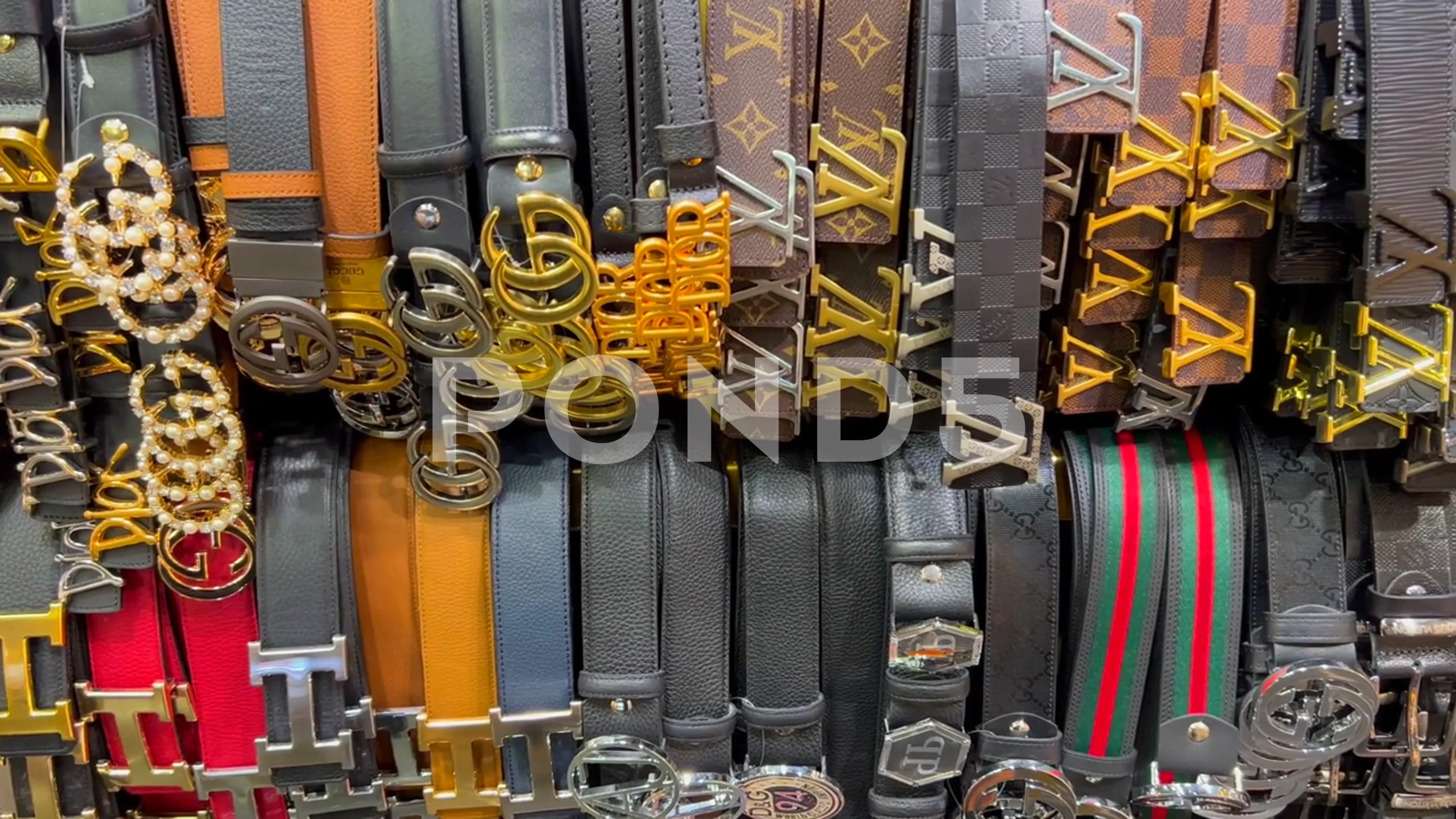 High quality fake designer belts hanging, Stock Video