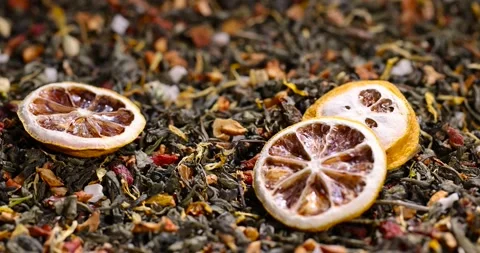 High-quality green tea with added flavors and pieces of fruit and cut yellow Stock Footage 328094780