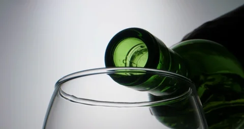 High quality red wine pouring into a glass in extreme slow motion, stream of Video stock 129334736