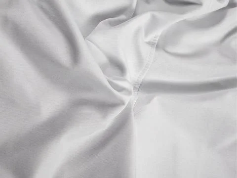 High-quality soft white fabric. The surface has beautiful folds. Stock Photos