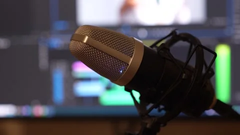 High-Quality Studio Microphone in Front of a Computer with Blurred Background Stock Footage 294707814