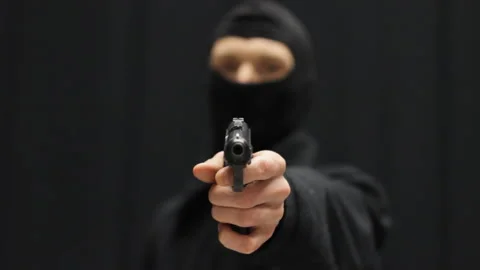 High quality studio video of an armed criminal in balaclava Stock Footage 233470841