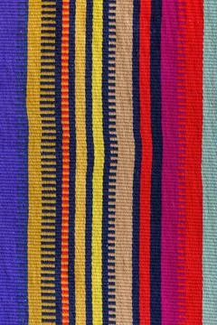 High quality texture of a multicolor vertical striped fabric in Mexican style. Stock Photos