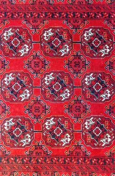 High quality texture of a real Persian carpet, red. Stock Photos