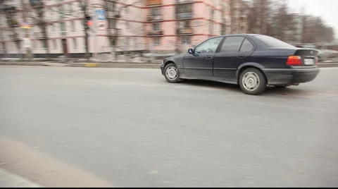 High quality tracking shot car make in U-turn, city street Stock Footage 973663