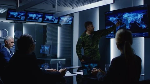 High-Ranking Military Man holds a Briefing to a Team of Government Agents Stock Footage