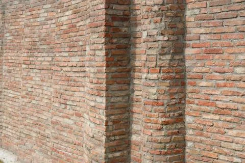 High red brick railing around the building. Brick wall corner, background. Stock Photos