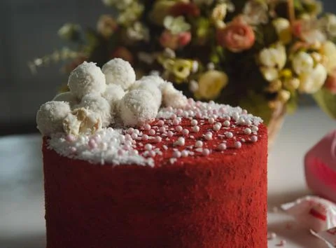 High red cake stands on a white table and piece of cake. Stock Photos