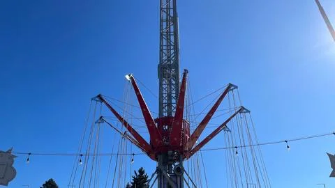 High red chain carousel tower against clear blue sky in amusement park on a.. Фото