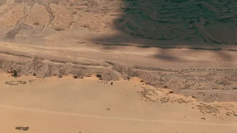 High-resolution aerial shot of a biker venturing into the raw wilderness of More Stock Footage 310899090