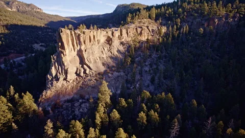 High-resolution aerial shot of steep rocky cliffs with scattered vegetation Video stock 332621300