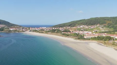 A high-resolution aerial video captures the sweeping coastline of Praia Da Stock Footage 346718133