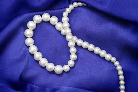 High resolution blue satin background with pearls Stock Photos