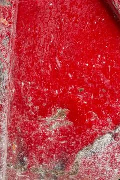 High-resolution capture of a deteriorating red-painted concrete wall Stock Photos