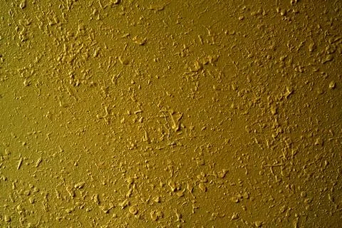 A high resolution close-up of a decorative yellow wall showing large paint drips Stock Photos