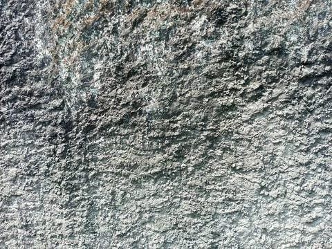 A high-resolution close-up image of a rough, natural stone texture Stock Photos