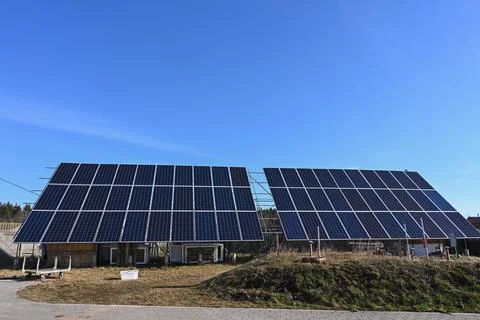 High resolution front view of solar panels against a clear blue sky Stock Photos