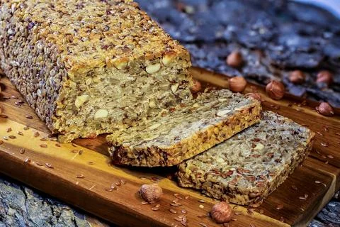 A high-resolution image capturing a close-up of a nut and seed bread loaf and Stock Photos
