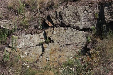High-resolution image of a natural stone surface captured in a wider outdoor vie Stock Photos