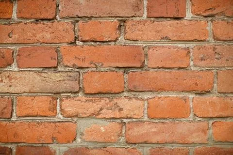 A high-resolution image of a rustic red brick wall. Stock Photos