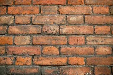 A high-resolution image of a rustic red brick wall. Stock Photos
