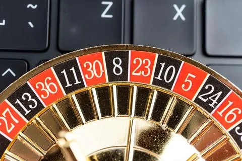 A high-resolution image showcases a roulette wheel with number 12 at its ce.. Stock Photos