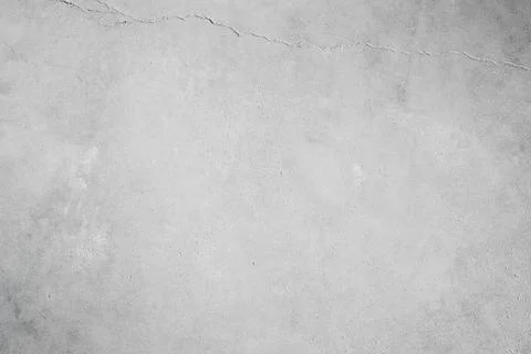 High-resolution light gray concrete wall texture with a subtle vintage crack. Stock Photos